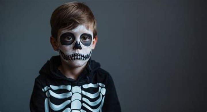 a boy in a skeleton costume 