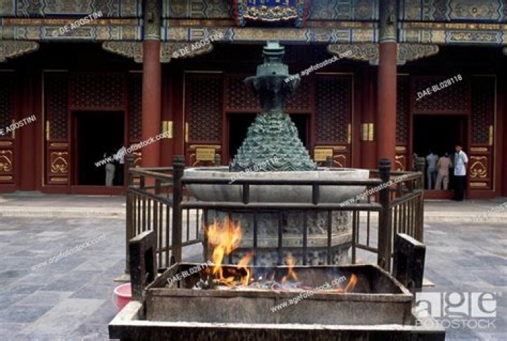 Several braziers in a temple in Fortnite that are lit with red flames